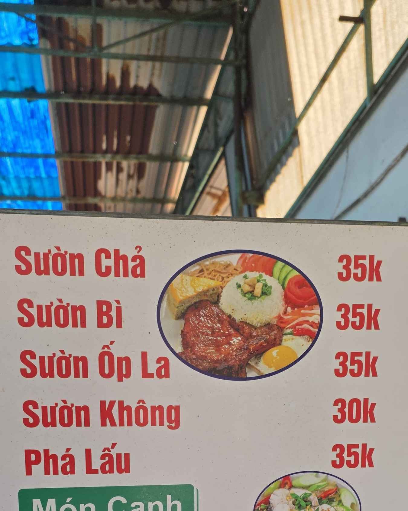 A printed Vietnamese menu on a café table, photographed from above.